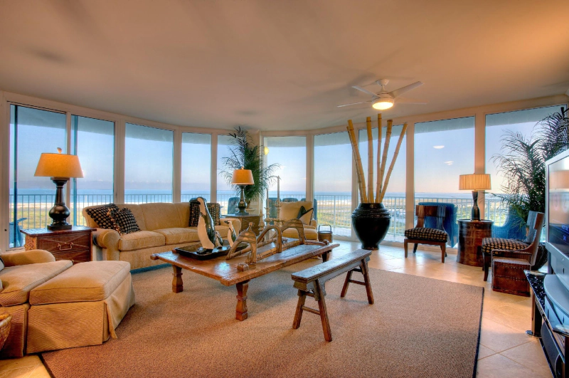 living room with large floor to ceiling windows overlooking the water