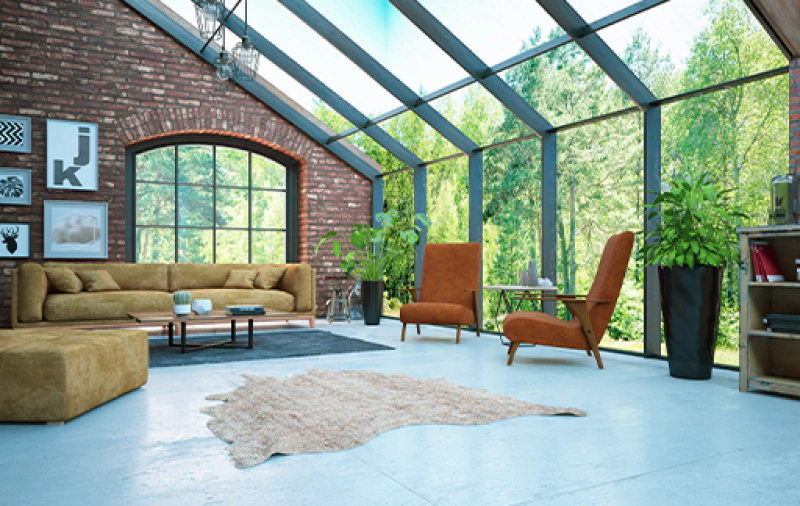 sunroom in home with large windowed wall and pitched roof